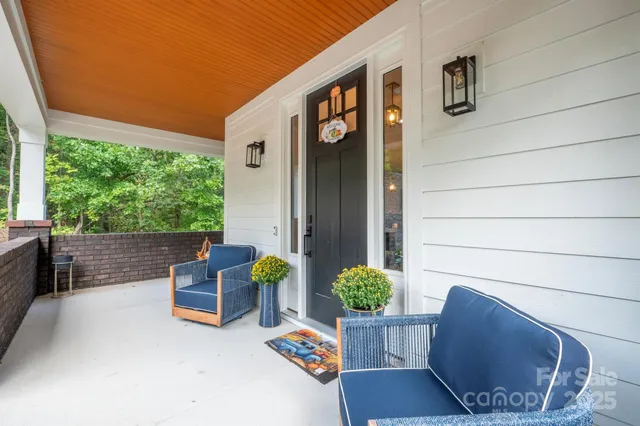 a view of backyard with outdoor seating and plants
