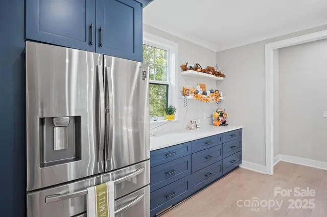 a large kitchen with a table and chairs