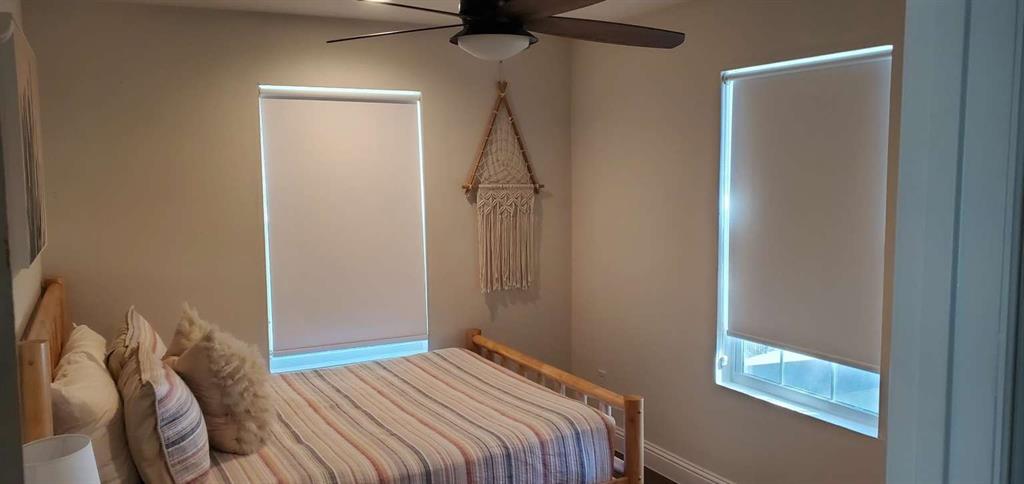 7102 Tejas Bend Mabank, TX 75156 - Photo 14 of 20 a bedroom with a bed and a chandelier fan