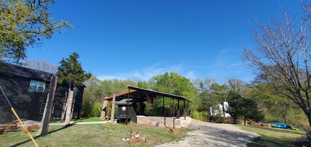 7102 Tejas Bend Mabank, TX 75156 - Photo 4 of 20 a view of a barn in the middle of a yard
