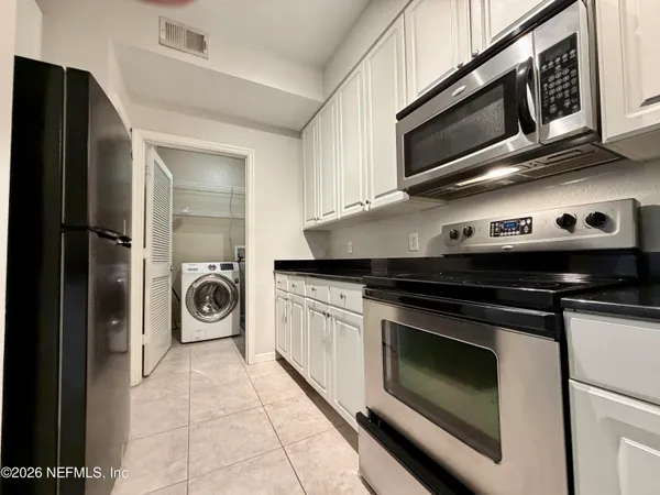 a kitchen with a stove and a microwave