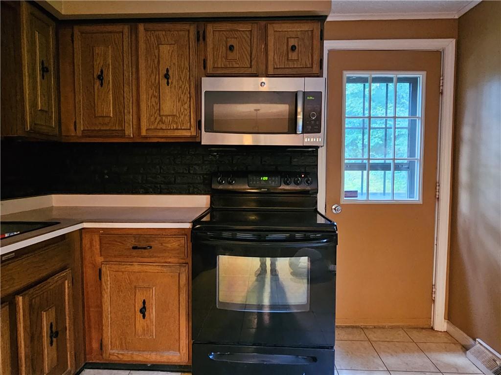 261 Whitestown Road Butler, PA 16001 - Photo 7 of 43 a kitchen with granite countertop a stove and a microwave