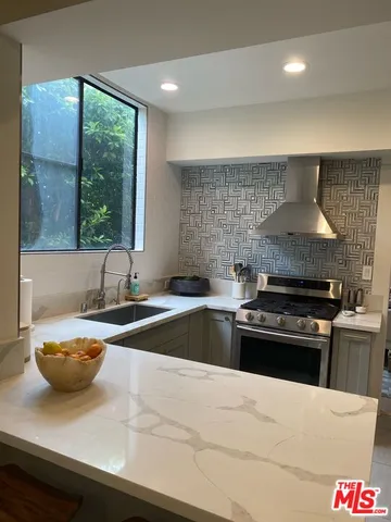 a kitchen with a stove and a sink