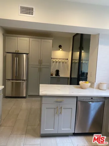a kitchen with stainless steel appliances a refrigerator and a stove