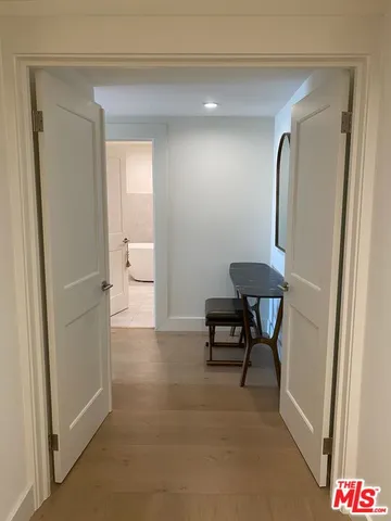 a view of a elevator and a mirror in a bathroom