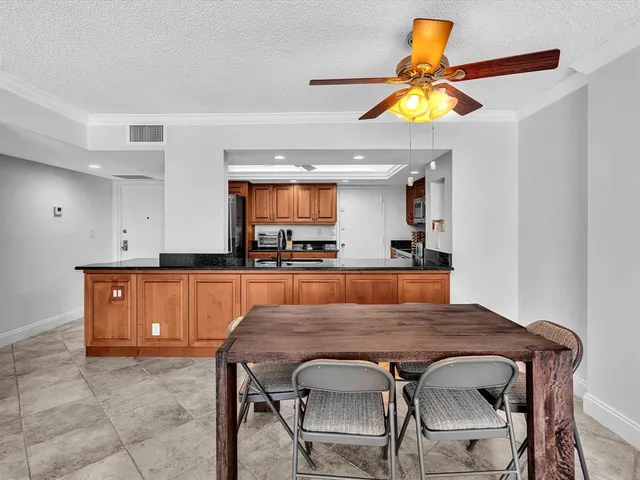 a living room with furniture a flat screen tv and a floor to ceiling window