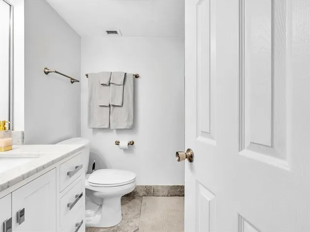 a bathroom with a granite countertop sink a mirror and a