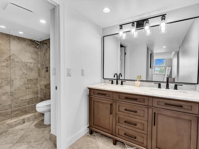 a living room with furniture and a dining table with kitchen view