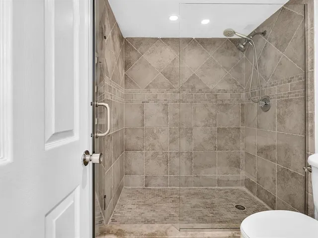 a living room with furniture a flat screen tv and a large window