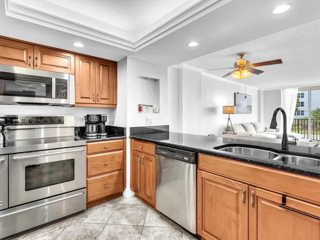 a kitchen with stainless steel appliances granite countertop a sink and cabinets