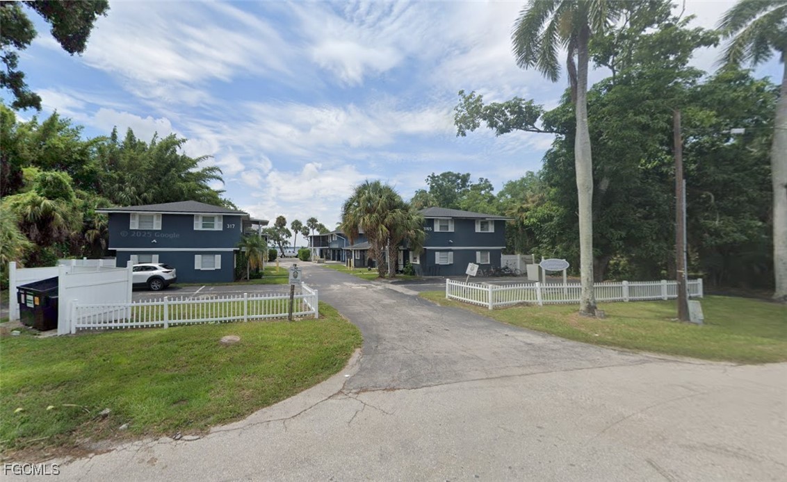 3165 East Riverside Drive, Unit 3175 Fort Myers, FL 33916 - Photo 2 of 8 a view of house with a big yard and potted plants