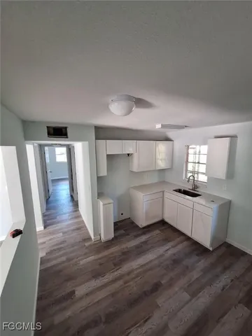 a kitchen with a wooden floor and white appliances