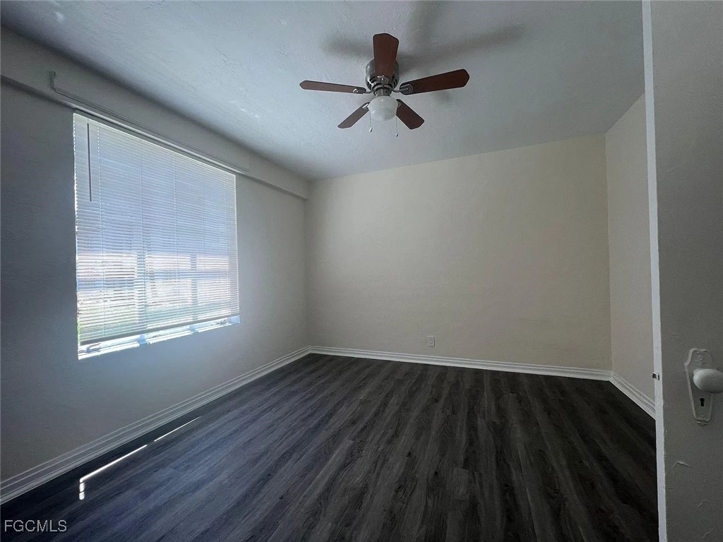 3165 East Riverside Drive, Unit 3175 Fort Myers, FL 33916 - Photo 6 of 8 a view of empty room with wooden floor and fan