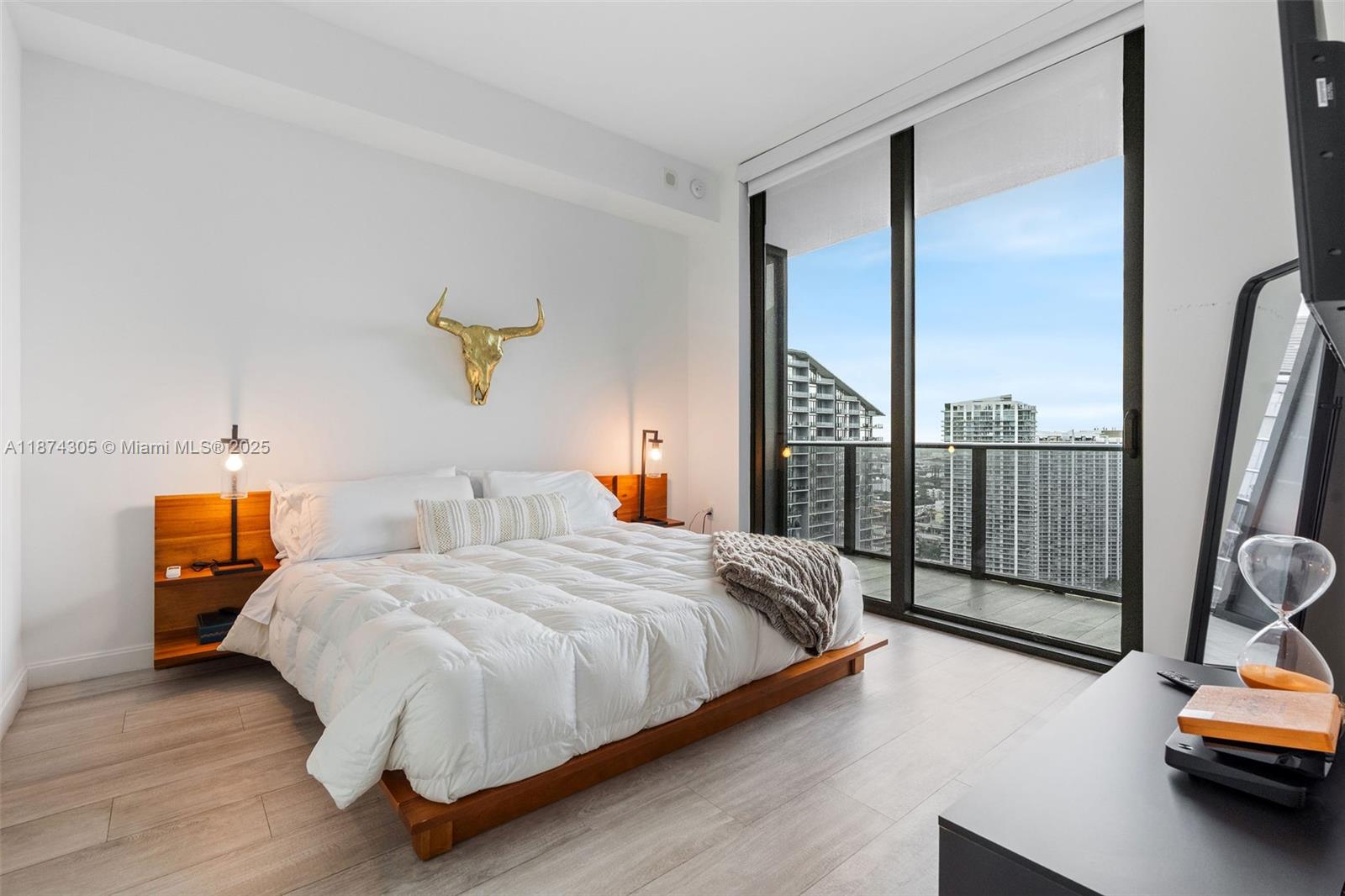 45 Southwest 9th Street, Unit 4301 Miami, FL 33130 - Photo 11 of 30 a bedroom with a bed and wooden floor