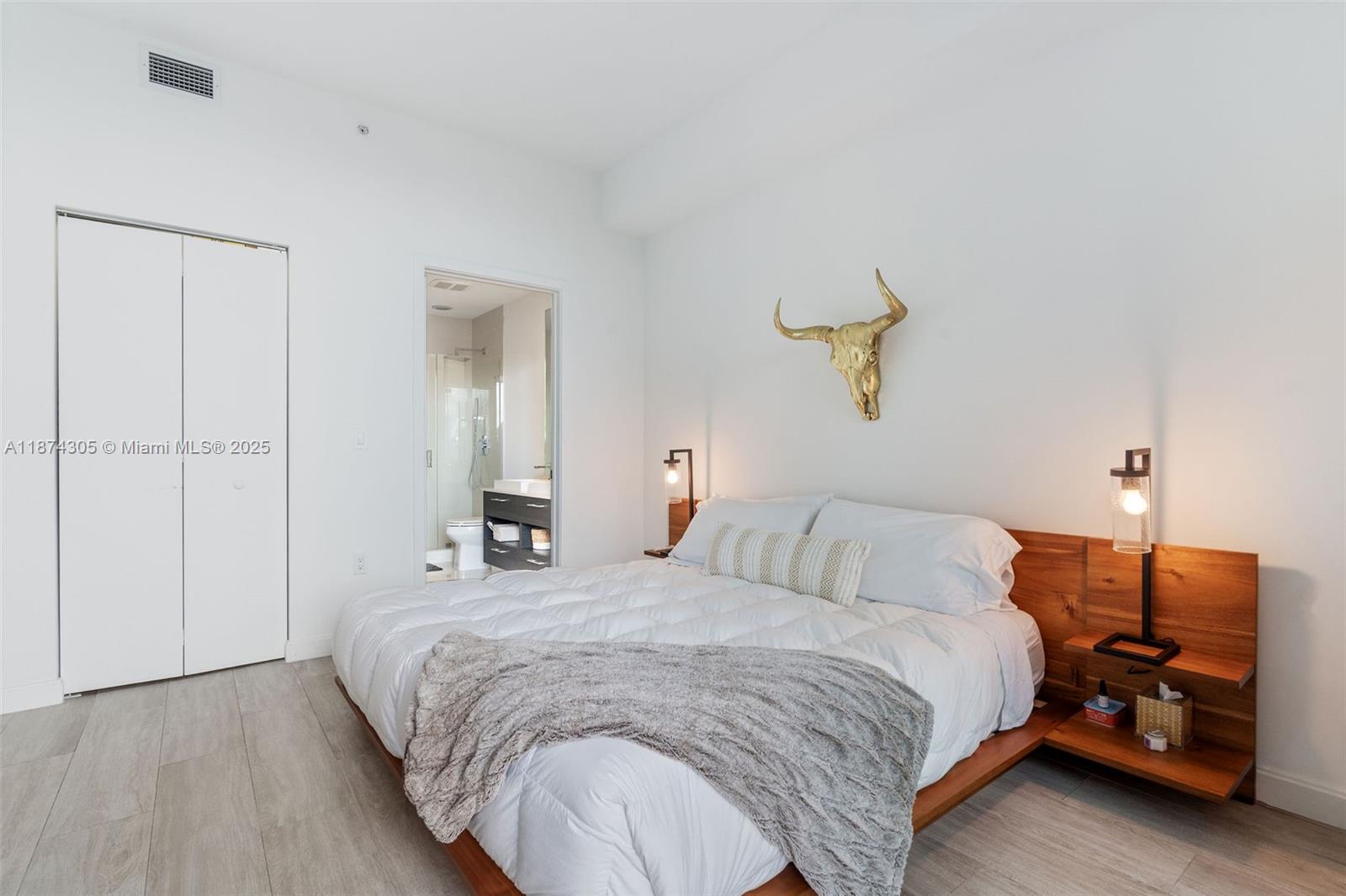 45 Southwest 9th Street, Unit 4301 Miami, FL 33130 - Photo 12 of 30 a bedroom with a bed and a chandelier