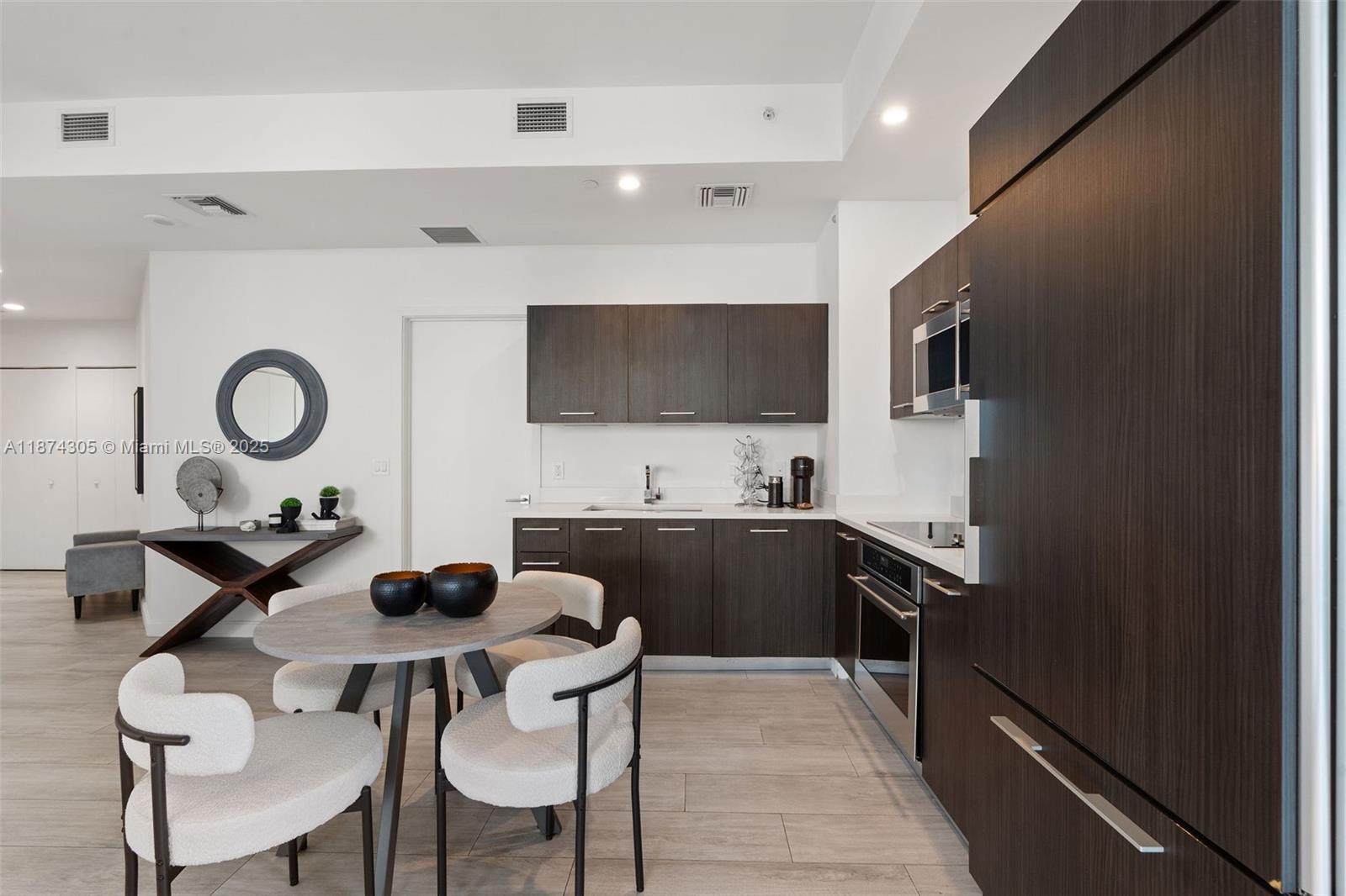 45 Southwest 9th Street, Unit 4301 Miami, FL 33130 - Photo 5 of 30 a kitchen with stainless steel appliances a stove a sink a microwave and a refrigerator