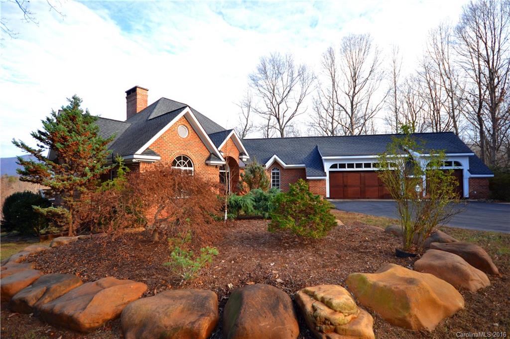 969 Hunting Country Road Tryon, NC 28782 - Photo 1 of 23 a front view of house with yard and trees in the background