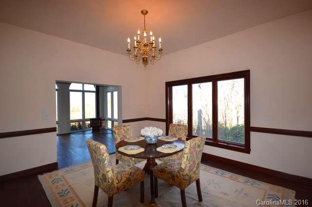 969 Hunting Country Road Tryon, NC 28782 - Photo 7 of 23 a view of a dining room with furniture window and wooden floor