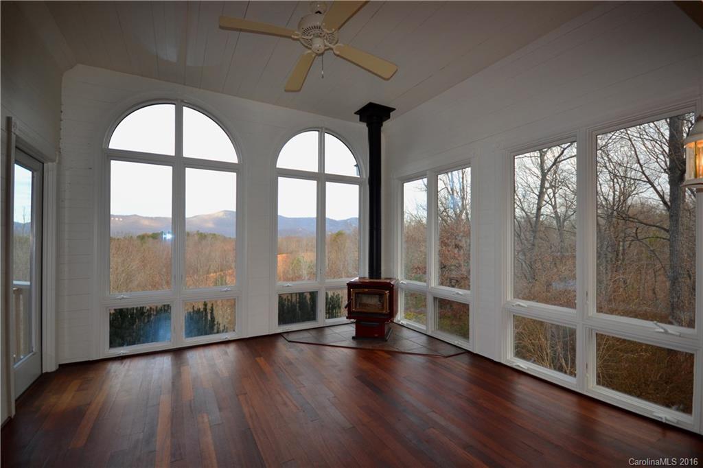 969 Hunting Country Road Tryon, NC 28782 - Photo 9 of 23 a view of empty room with wooden floor and fan