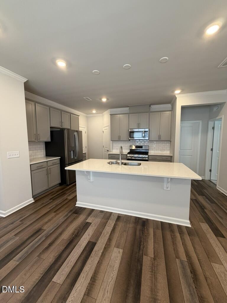 2509 Salt River Lane Raleigh, NC 27616 - Photo 14 of 34 a large kitchen with kitchen island a sink stainless steel appliances and cabinets