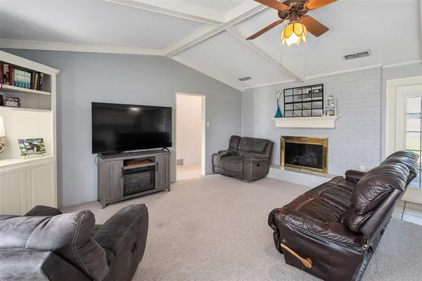 a living room with furniture and a fireplace