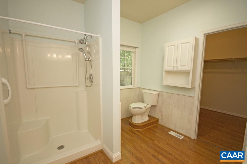 1 Foxmoor Road Troy, VA 22974 - Photo 12 of 25 a bathroom with a granite countertop shower a toilet and a sink