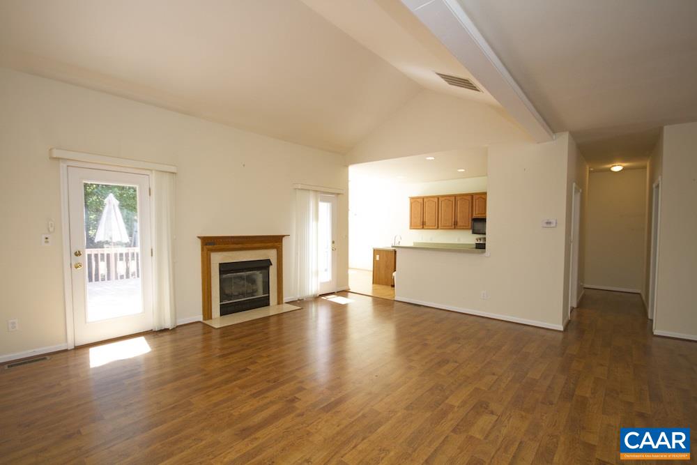 1 Foxmoor Road Troy, VA 22974 - Photo 5 of 25 an empty room with wooden floor fireplace and windows