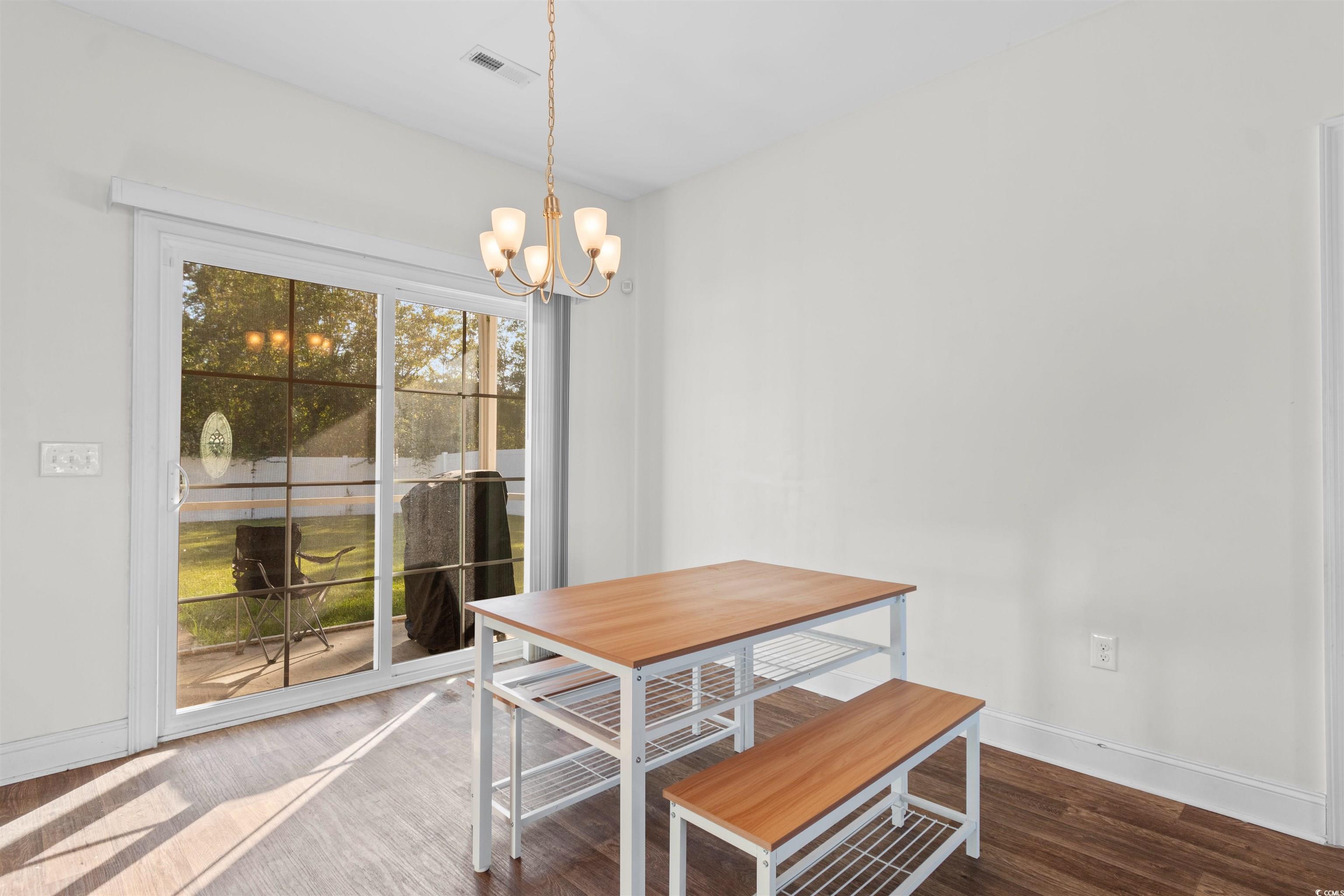 253 Maple Oak Drive Conway, SC 29526 - Photo 13 of 33 Dining area featuring wood finished floors and a chandelier