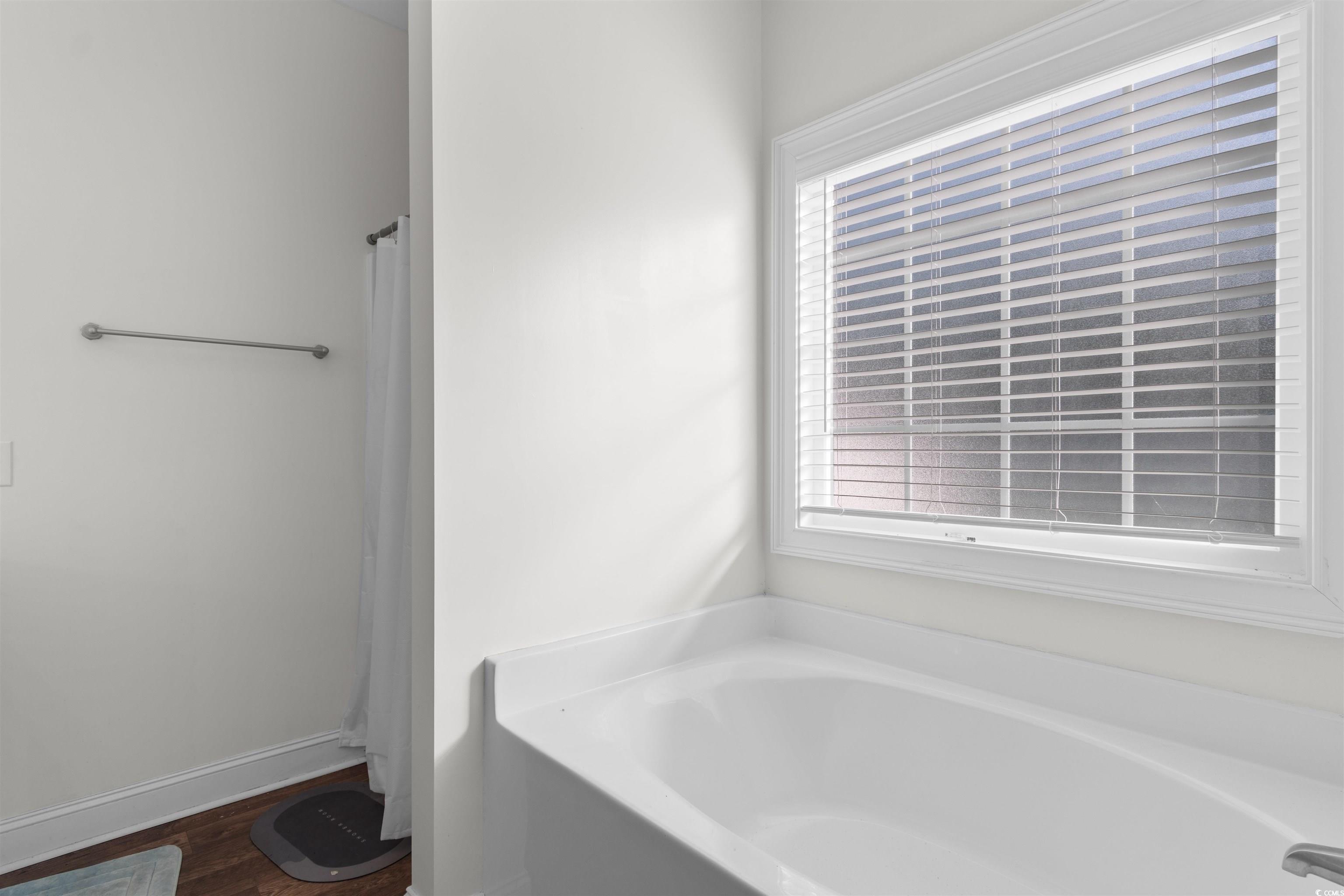 253 Maple Oak Drive Conway, SC 29526 - Photo 17 of 33 Full bathroom featuring a bath, dark wood finished floors, and a shower with shower curtain