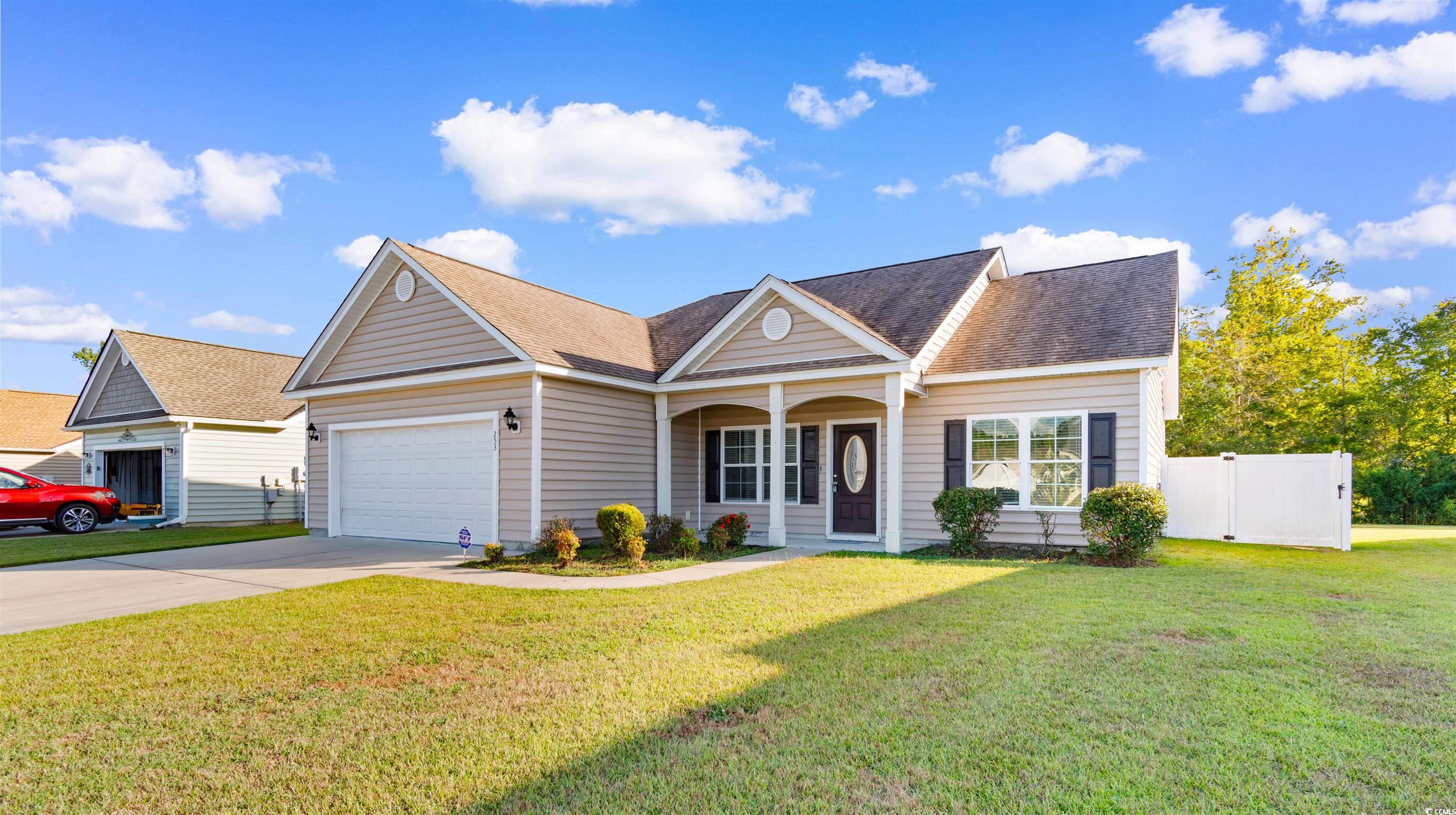 253 Maple Oak Drive Conway, SC 29526 - Photo 2 of 33 View of front of house with driveway, a porch, a shingled roof, and an attached garage