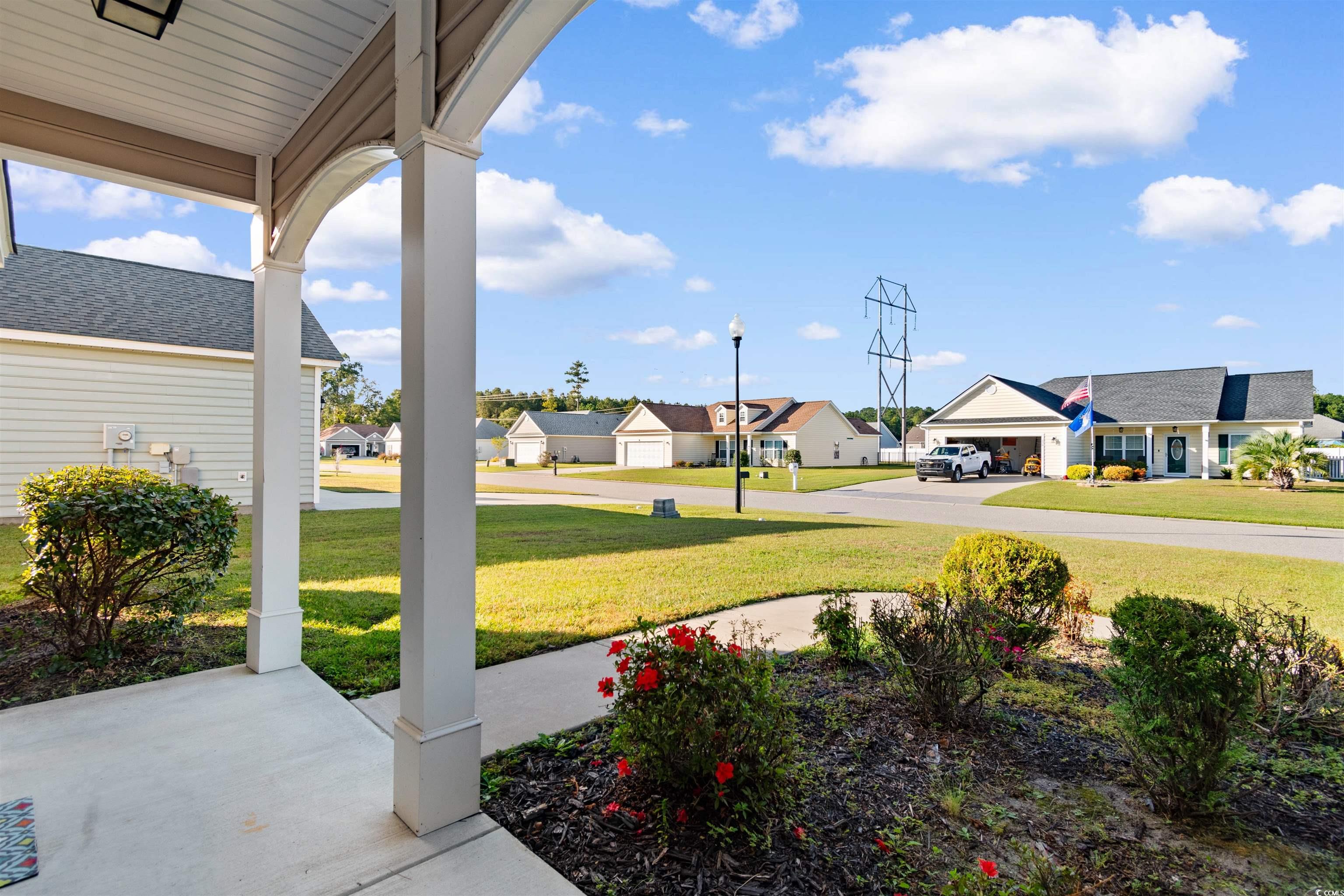 253 Maple Oak Drive Conway, SC 29526 - Photo 4 of 33 View of grassy yard with a porch and a residential view
