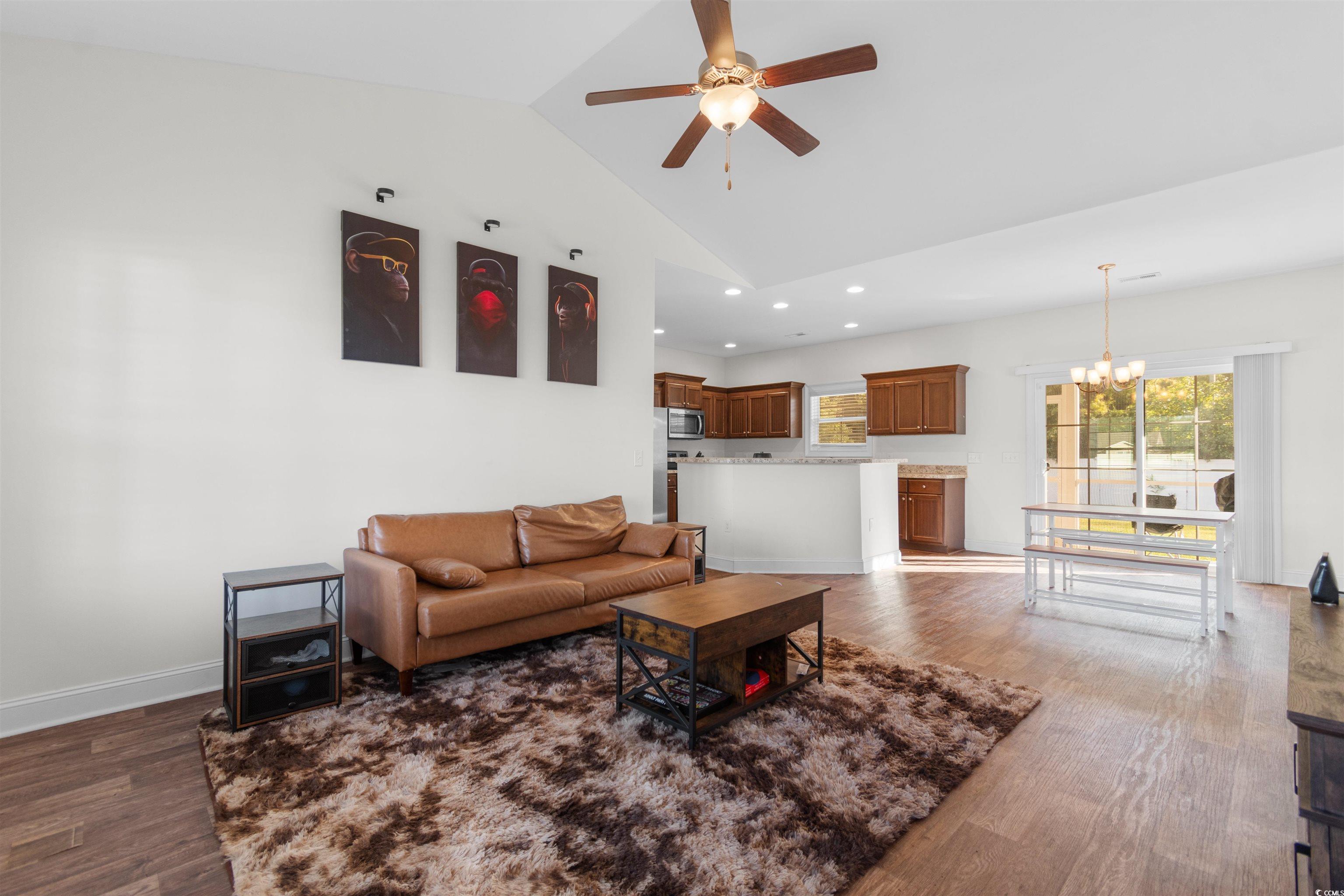 253 Maple Oak Drive Conway, SC 29526 - Photo 6 of 33 Living area with dark wood finished floors, lofted ceiling, a chandelier, recessed lighting, and a ceiling fan