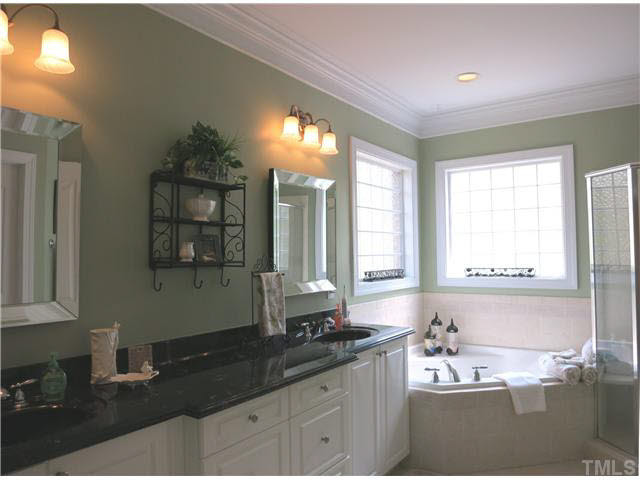 7209 Sparhawk Road Wake Forest, NC 27587 - Photo 13 of 25 The spacious Master Bath offers a whirlpool tub under corner glass block windows, separate tiled shower w/seat, tile floor, long vanity w/double sinks & private toilet rm. Master Bath/Spa