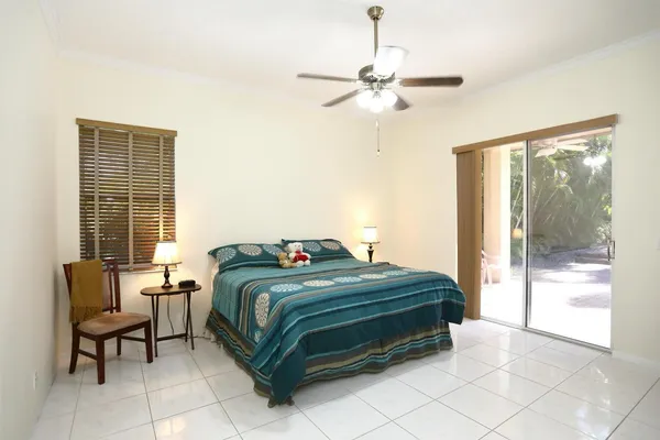 a living room with furniture a flat screen tv and kitchen view