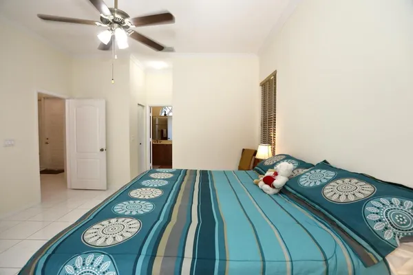 a living room with furniture a ceiling fan and a window