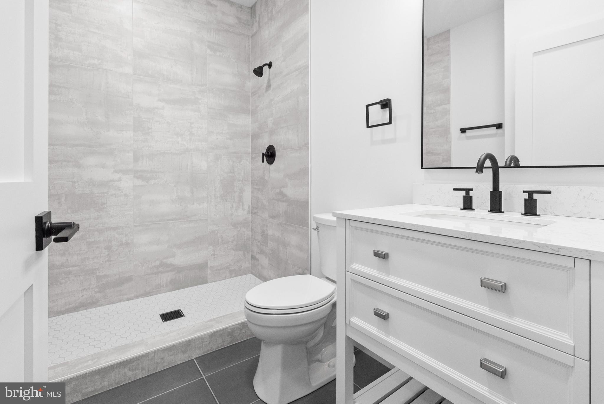 1321 Nicodemus Road Reisterstown, MD 21136 - Photo 15 of 30 a bathroom with a sink a toilet and shower