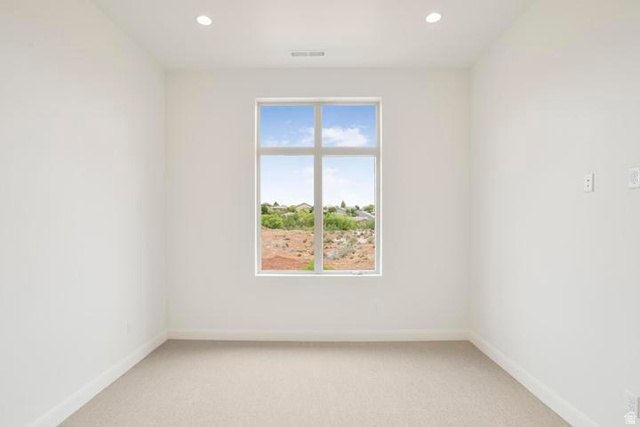 990 Manen Street Washington, UT 84780 - Photo 18 of 43 Neutral interior featuring a large multi-pane window, recessed ceiling lighting, light-toned carpet, and clean white walls