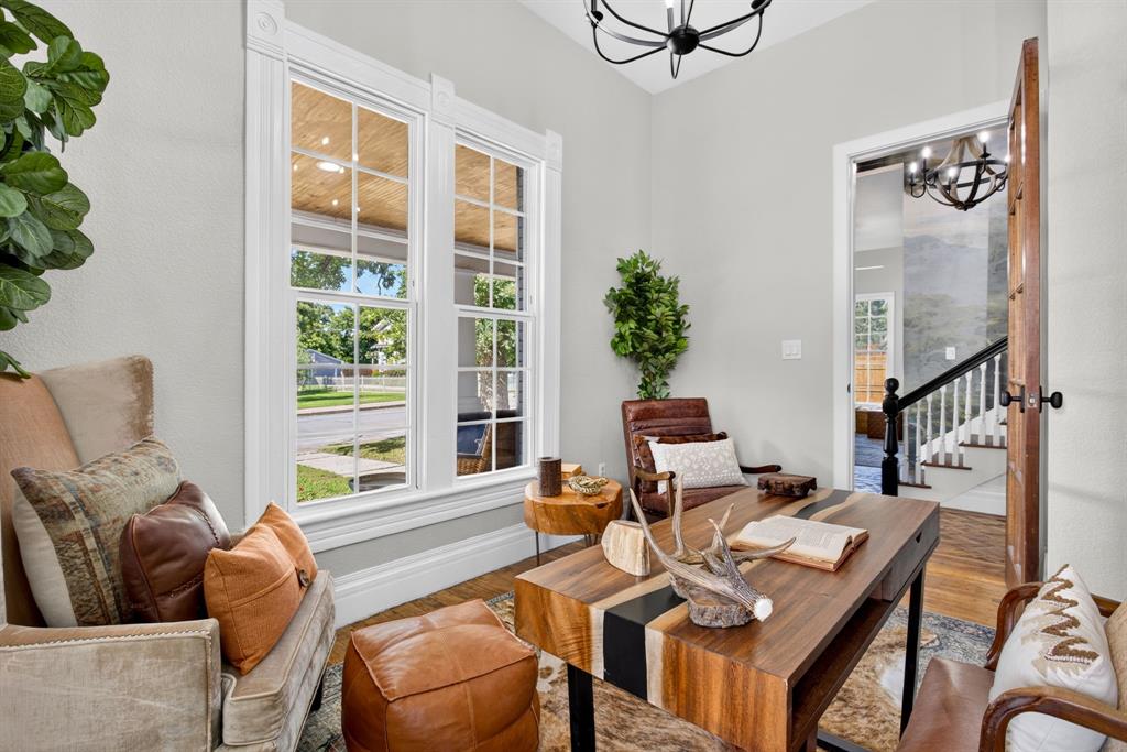 702 West Spring Street Weatherford, TX 76086 - Photo 9 of 39 Dedicated office space featuring two large sash windows with intricate trim work, a paneled wood door, and a black wrought-iron chandelier