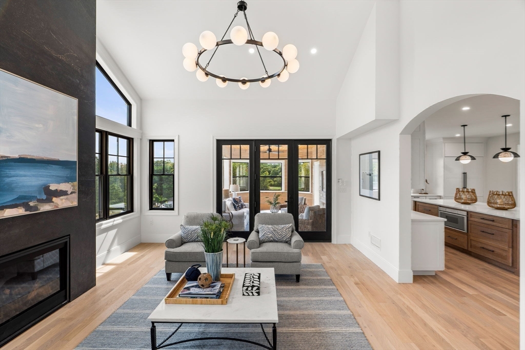 226 Atlantic Street Gloucester, MA 01930 - Photo 11 of 37 a living room with furniture dining table and a fireplace