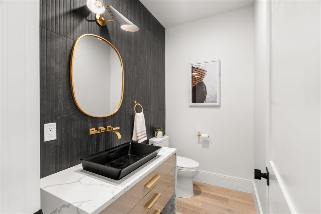 226 Atlantic Street Gloucester, MA 01930 - Photo 13 of 37 a bathroom with a toilet a sink and mirror