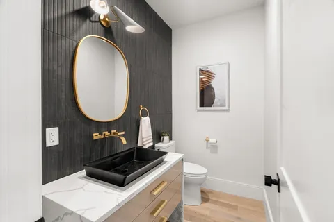 a bathroom with a toilet a sink and mirror