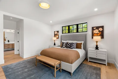 a spacious bedroom with two beds and a chair