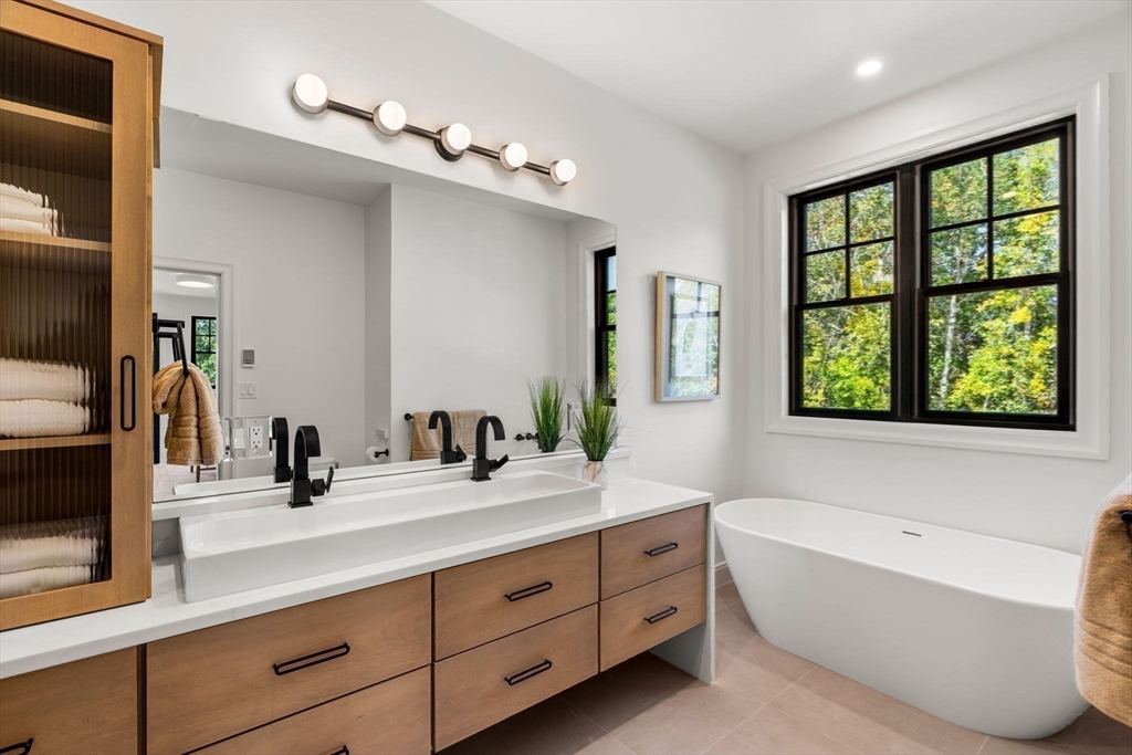 226 Atlantic Street Gloucester, MA 01930 - Photo 16 of 37 a bathroom with a large tub sink and mirror