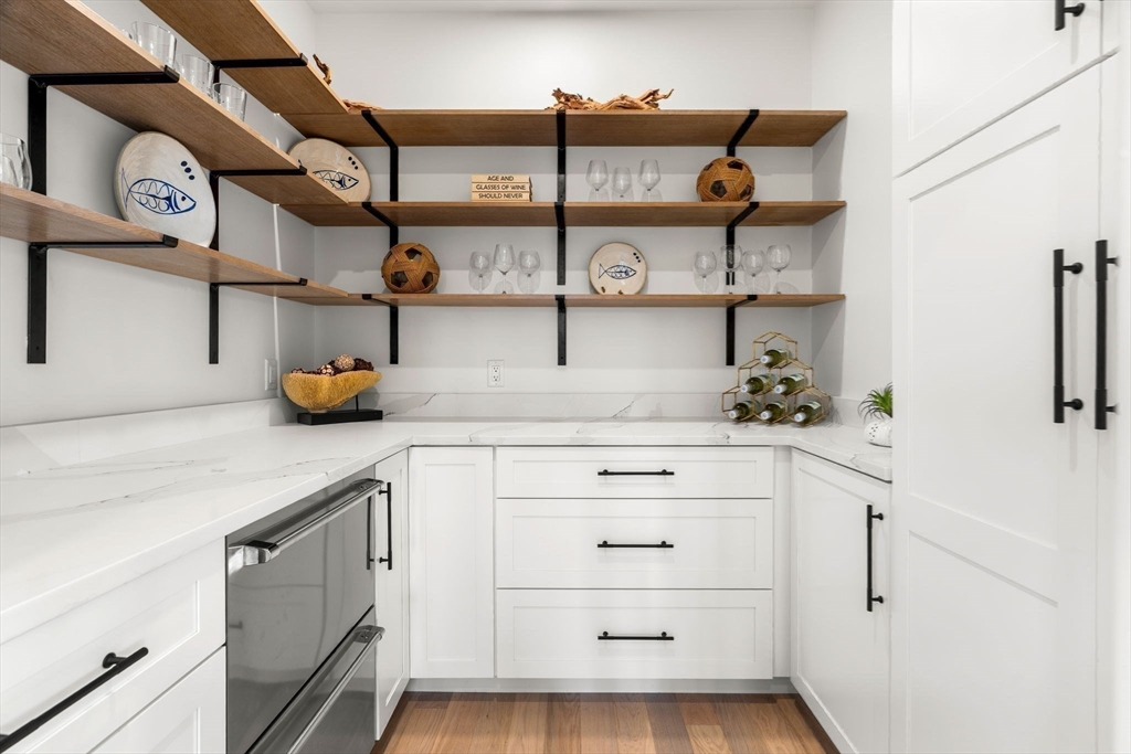 226 Atlantic Street Gloucester, MA 01930 - Photo 5 of 37 a kitchen with a refrigerator and white cabinets