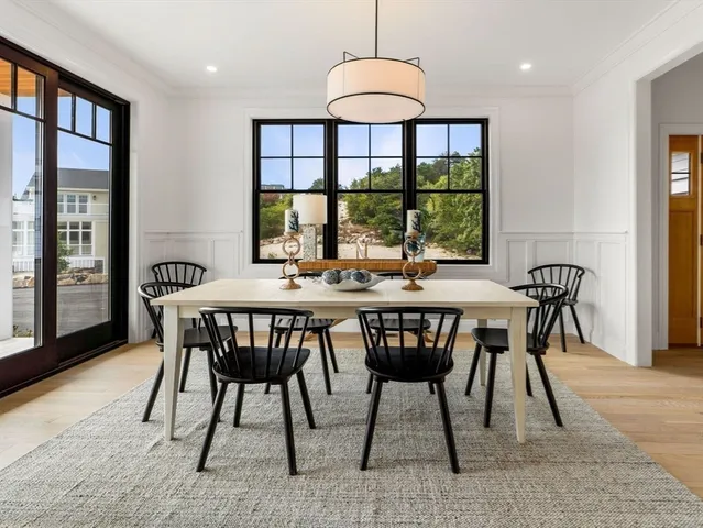 a living room with furniture a fireplace and a large window