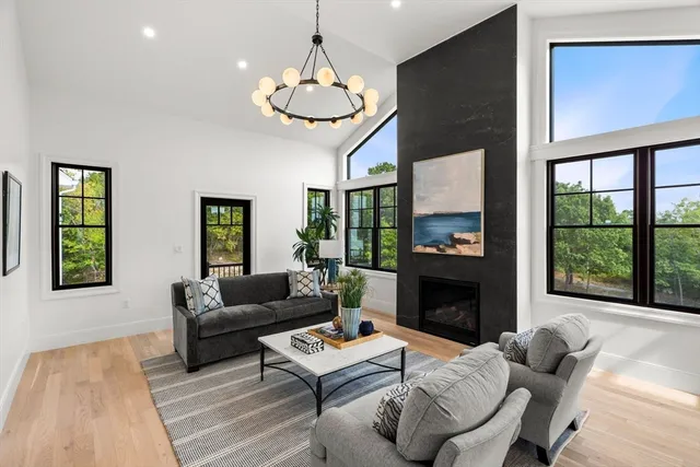 a living room with furniture dining table and a fireplace