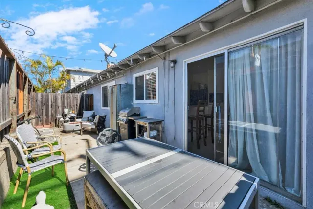 a living room with furniture a window and a flat screen tv