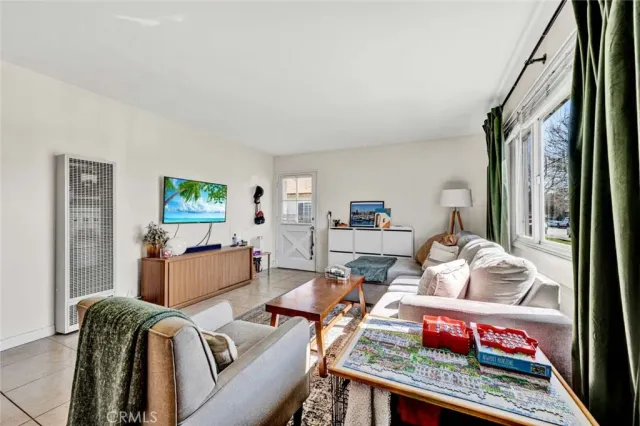 a dining room with furniture and a window