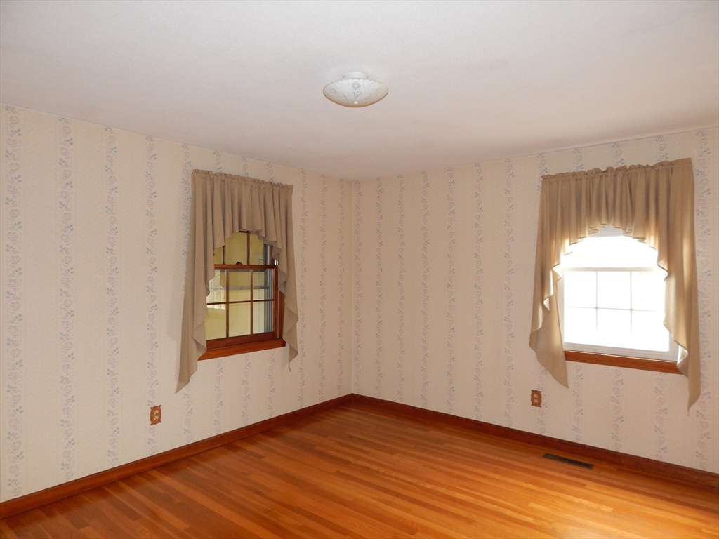 8 Chester Street Montague, MA 01376 - Photo 17 of 32 an empty room with wooden floor and windows