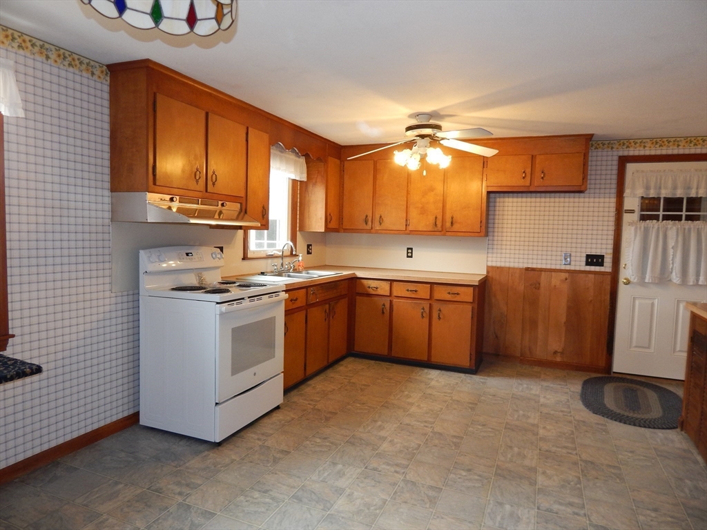 8 Chester Street Montague, MA 01376 - Photo 4 of 32 a kitchen with a stove sink and cabinets